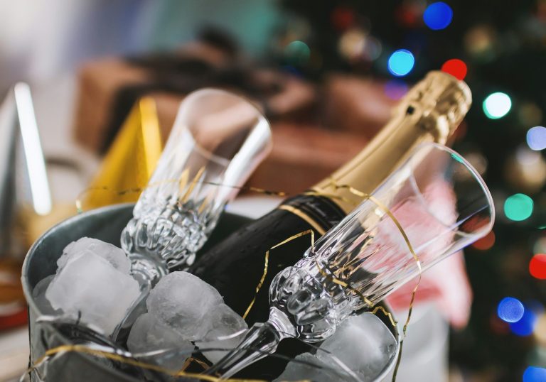Two champagne glasses and a bottle of champagne in an ice bucket
